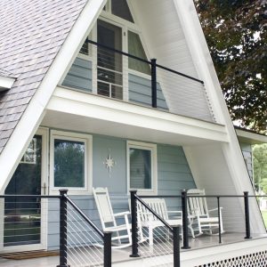 Composite front deck with cable railing on an A-frame cottage, West Michigan composite deck builders
