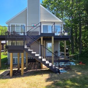 Elevated deck and stairs on an A-frame cottage in the woods, West Michigan deck and stair builders