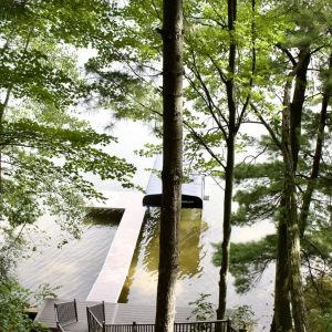 Black aluminum stairs down a wooded bluff to the water, Lake Michigan aluminum stair builders