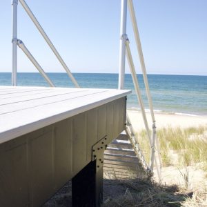 Composite beach deck with cable railing posts above the Lake Michigan shoreline, composite deck builders