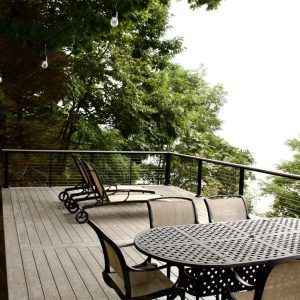 Composite deck with black railing and dining table overlooking the lake, West Michigan composite deck builders