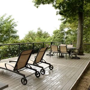 Composite deck with lounge chairs and cable railing at a lakefront home, West Michigan composite deck builders