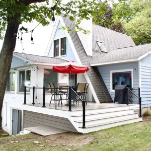 Composite deck and steps with black railing on a lakeside cottage, West Michigan composite deck builders