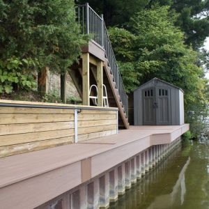 Seawall with composite cap, stairs and storage shed at a lakefront lot, West Michigan seawall builders