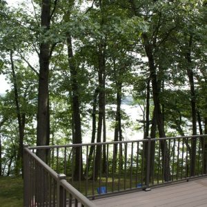 Wood deck with railing on a wooded lakefront lot, West Michigan wood deck builders